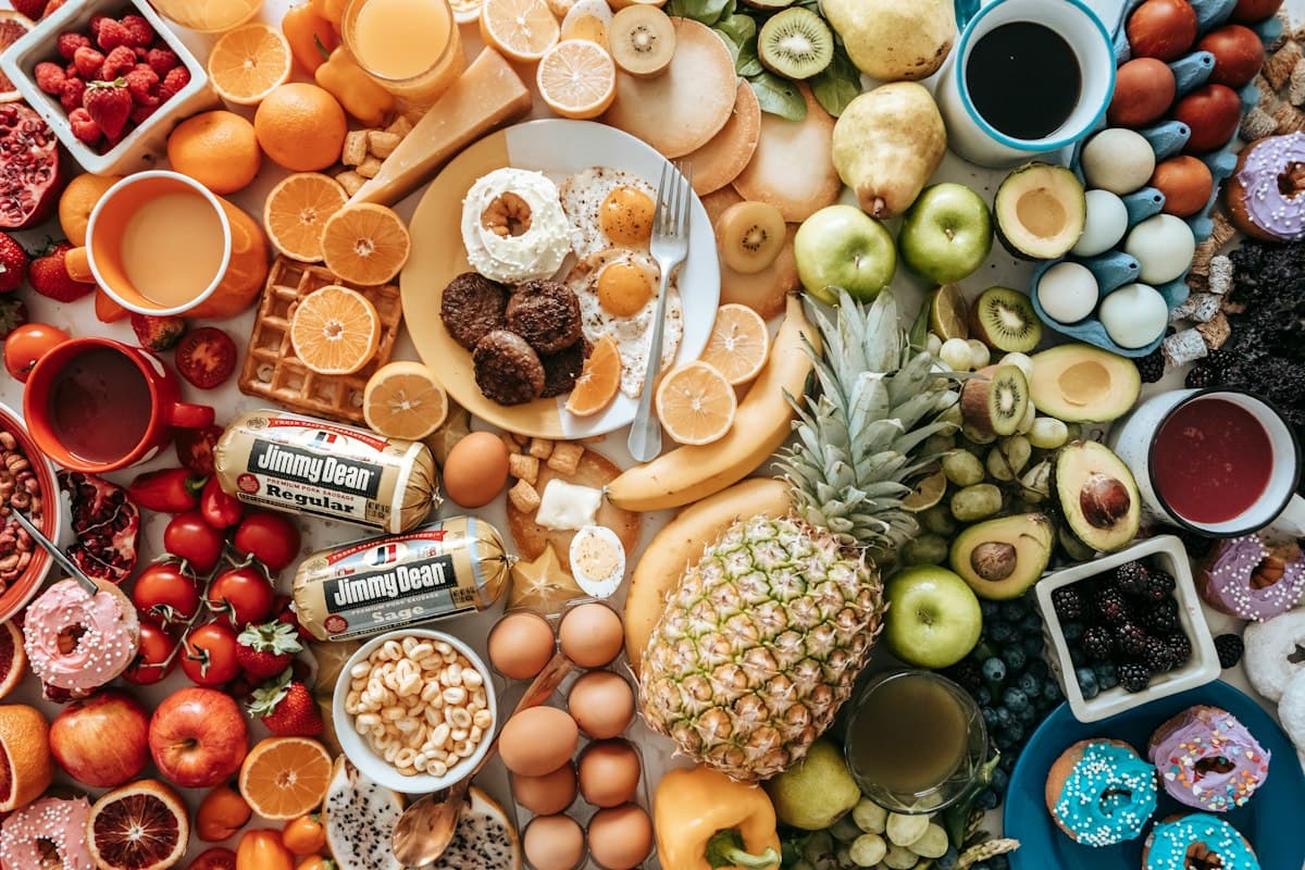 A table covered in fruit, nuts, pastries and doughnuts